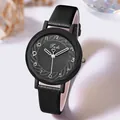 Detailed close-up of a ladies' black quartz watch with sunburst dial and leather strap - Black