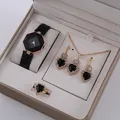 Close-up of black and gold jewelry set with octagon watch and heart pendants - Rose Gold Black Heart