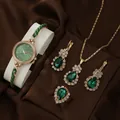 Elegant rose gold women's quartz watch and green gemstone jewelry set on brown satin - Waterdrop Style Watch Necklace Ring Earrings / Green