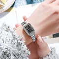 Close-up of elegant square quartz watch with silver steel band on a female wrist - Silver Black Dial