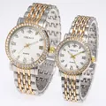 Detailed view of luxury couple quartz watches with gold-tone steel bands and diamond bezels - Men Two-tone White