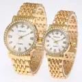 Detail of couple watches with gold metal bands, rhinestone bezels and Roman numerals - Men's Gold White Dial