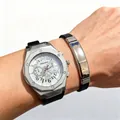 Macro shot of silver skeleton quartz watch with octagonal bezel and black rubber strap - White Face With Bracelet