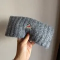 Close-up of grey knit headband featuring embroidered puppy with a red bow detail - Dark Gray