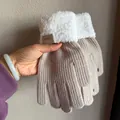 Detail of khaki knit gloves with white faux fur cuffs and a leather brand patch - Beige