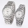 A pair of silver couple watches featuring white dials with Roman numerals and rhinestones - Men's Silver Case White Dial