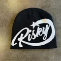 Detail of black knit beanie featuring white Risky jacquard text and star pattern - M(54-59) / Black
