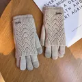 Close-up of beige knit double-layer gloves with fashion metal logo and touchscreen tips - One Size / Beige