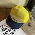 Close-up of a 5-panel mesh hat featuring yellow breathable fabric and brand logo - Adjustable / Washed Navy & Red