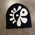 Close-up of black knitted beanie featuring white abstract street art graphic print - M / Black