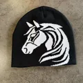 Detail of horse head jacquard pattern on a black knitted winter beanie hat - M (52-59) / Black
