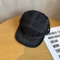 Détail de la casquette five-panel en denim noir avec surpiqûres blanches et œillets - Réglable / Noir