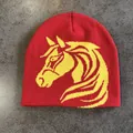 Detail of red knitted beanie featuring a yellow jacquard horse head pattern for winter - M (52-59) / Red