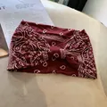 Elastic wide headband in burgundy paisley print with stylish center knot twist design - Burgundy