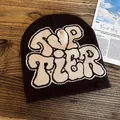 Detailed knit pattern on dark brown beanie featuring ivory TOP TIER letter design - One Size / Coffee