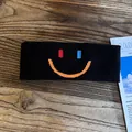 Close-up of black sports headband with colorful embroidered smile face on wood surface - Black