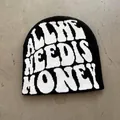 Close-up of black knit beanie with white ALL WE NEED IS HONEY jacquard lettering - One Size / Black + White Letters
