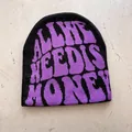 Detail of black knitted beanie featuring purple jacquard text on textured background - One Size / Black With Purple Letters