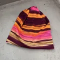 Detail of soft knitted beanie showing colorful horizontal stripes and ribbed texture - One Size (55-58cm) / Orange Red
