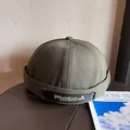 Close-up of olive green docker hat featuring adjustable black strap and masicM embroidery - Adjustable / Army Green
