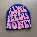 Detail of royal blue knitted beanie with pink jacquard slogan text on gray surface - One Size / Sapphire Blue