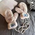 Detail of plush beige mittens featuring a cute koala patch and woven neck string - Beige