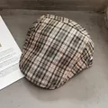 Flat lay of vintage plaid newsboy cap in beige and green on a stylish background - One Size / Khaki Green Plaid