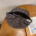 Detail of vintage plaid newsboy cap featuring an adjustable metal buckle and woven side label - Adjustable / Blue