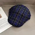 Flat lay of vintage plaid newsboy cap in navy blue and brown with woven texture detail - One Size / Royal Blue Black Plaid
