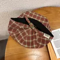 Detailed shot of retro plaid newsboy cap with metal buckle on a rustic wooden table - Adjustable / Burgundy
