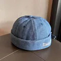 Detail of dark blue washed denim docker hat with white 'Magic' embroidery on the side - Adjustable / Medium Blue
