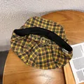 Detail of adjustable metal buckle and vintage checkered fabric on the retro beret hat - Adjustable / Yellow