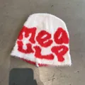 Detail of white plush knitted hat with red jacquard lettering and soft faux fur texture - One Size / White