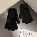Detailed shot of soft black faux fur gloves with a warm fluffy plush texture - Black