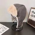 Detail of gray faux suede aviator hat with soft plush lining and UZI side leather patch - Gray