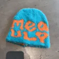 Detail of fuzzy bright blue knit beanie featuring contrasting orange letter jacquard texture - One Size / Lake Blue