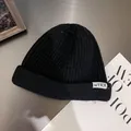 Classic black ribbed knit beanie with NTRX woven label for winter warmth and street style - M / Black