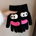 Close-up of black knitted gloves featuring a quirky cartoon face with large eyes and pink lips - Black