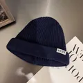 Detailed texture of dark blue ribbed knit beanie featuring an NTRX woven label - M / Navy Blue