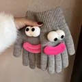 Detail of grey knitted gloves featuring funny cartoon 3D eyes and pink plush lips - Light Gray