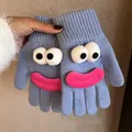 Detail of blue knitted gloves featuring cartoon funny face with big 3D eyes and pink lips - Sky Blue