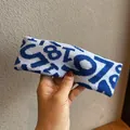 Detailed view of blue and white knitted sports headband with jacquard numeric pattern - Light Blue+Royal Blue