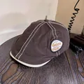 Close-up of brown vintage flat cap with contrast stitching and Gsior's CUP embroidery - M (55-59cm) / Coffee
