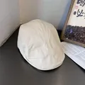 Detailed close-up of beige cotton newsboy cap with textured twill weave and retro stitching - M (55-58cm) / Beige