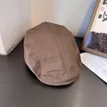 Detail of a vintage dark brown cotton newsboy cap showing texture and stitching on wood - M (55-58cm) / Coffee