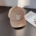 Close-up of khaki cotton baseball cap with white letter embroidery and stitched brim - Adjustable / Khaki
