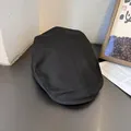Top view of black cotton twill newsboy cap showing stitched paneled construction detail - M (55-58cm) / Black