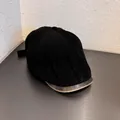 Detail of black corduroy fabric and brown vintage leather brim on a newsboy cap - M (55-59cm) / Black