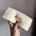 Detail of cream knitted headband featuring soft ribbed texture and red embroidered me text - Off White