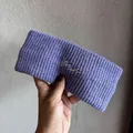 Nahaufnahme des fliederfarbenen Strickstirnbands mit Rippstruktur und Stickerei-Schrift - Lila
